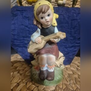 vintage bisque porcelain figurine of a girl with a guitar
